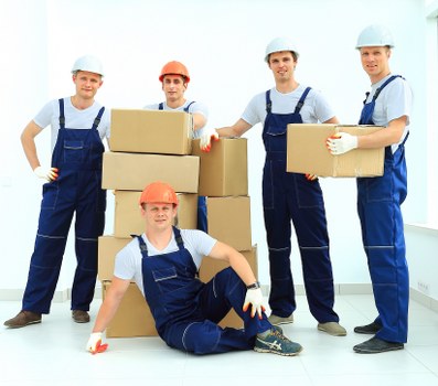 Removal team preparing furniture with safety equipment in Hampstead