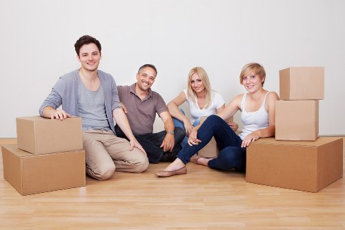 Professional movers protecting fragile items in a Hampstead removal process